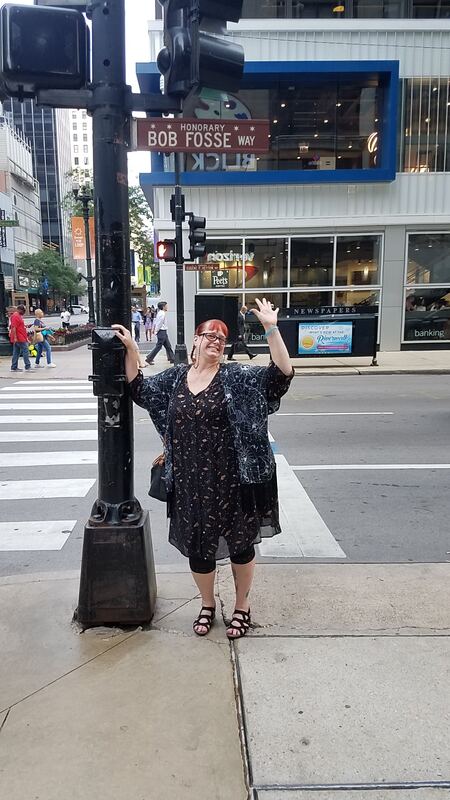 Kayleen points to the honorary street sign for Bob Fosse Way in Downtown Chicago.