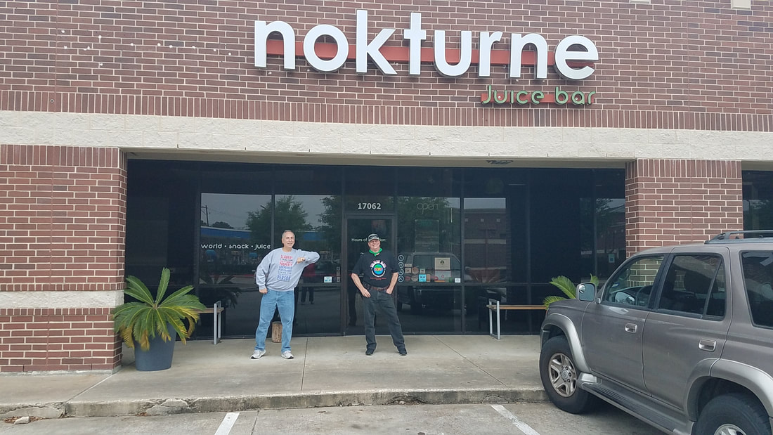 David B. Collins and Hal J. Ridley, Jr., in front of Nokturne restaurant and coffee shop
