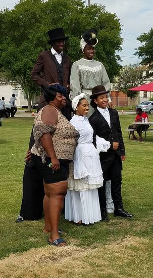Park visitors pose for pictures with young people in their 19th-century Sunday best.