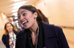 Rep.-elect Alexandria Ocasio-Cortez smiling in some generic DC corridor